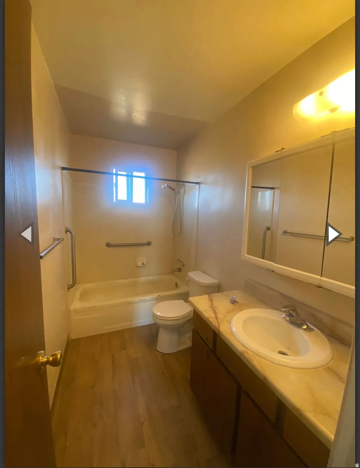 Full bathroom with vanity, dark wood-style flooring, and bathing tub / shower combination