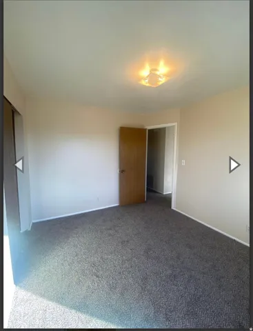 Unfurnished bedroom featuring carpet flooring and baseboards