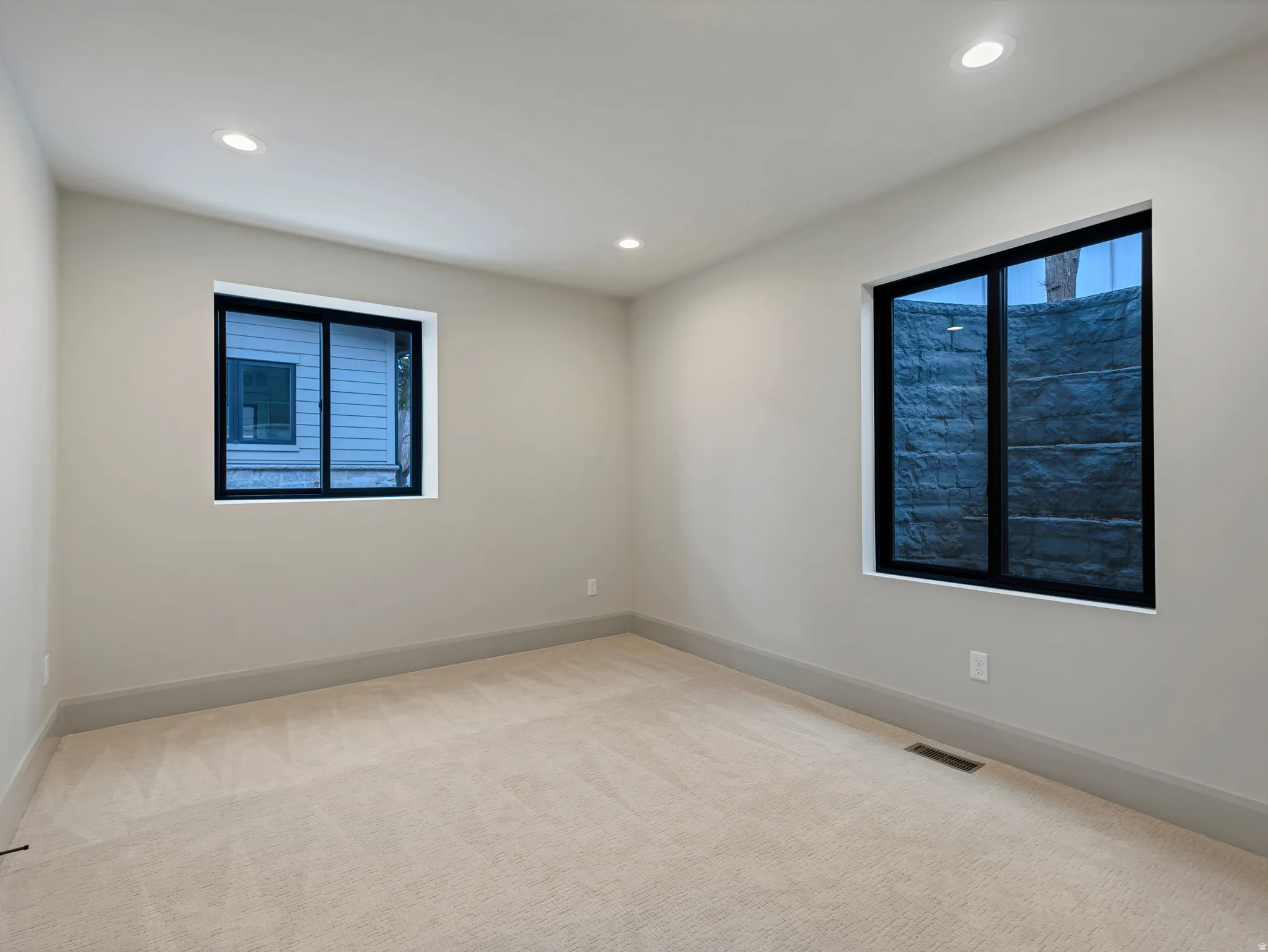 Spare room featuring light carpet and recessed lighting