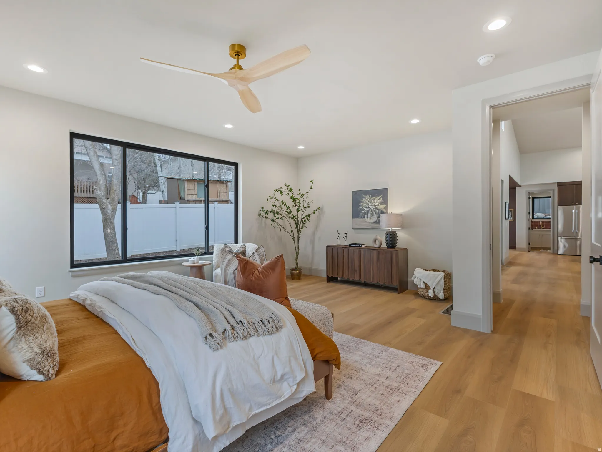 Bedroom featuring light wood-style flooring, high end fridge, ceiling fan, and recessed lighting