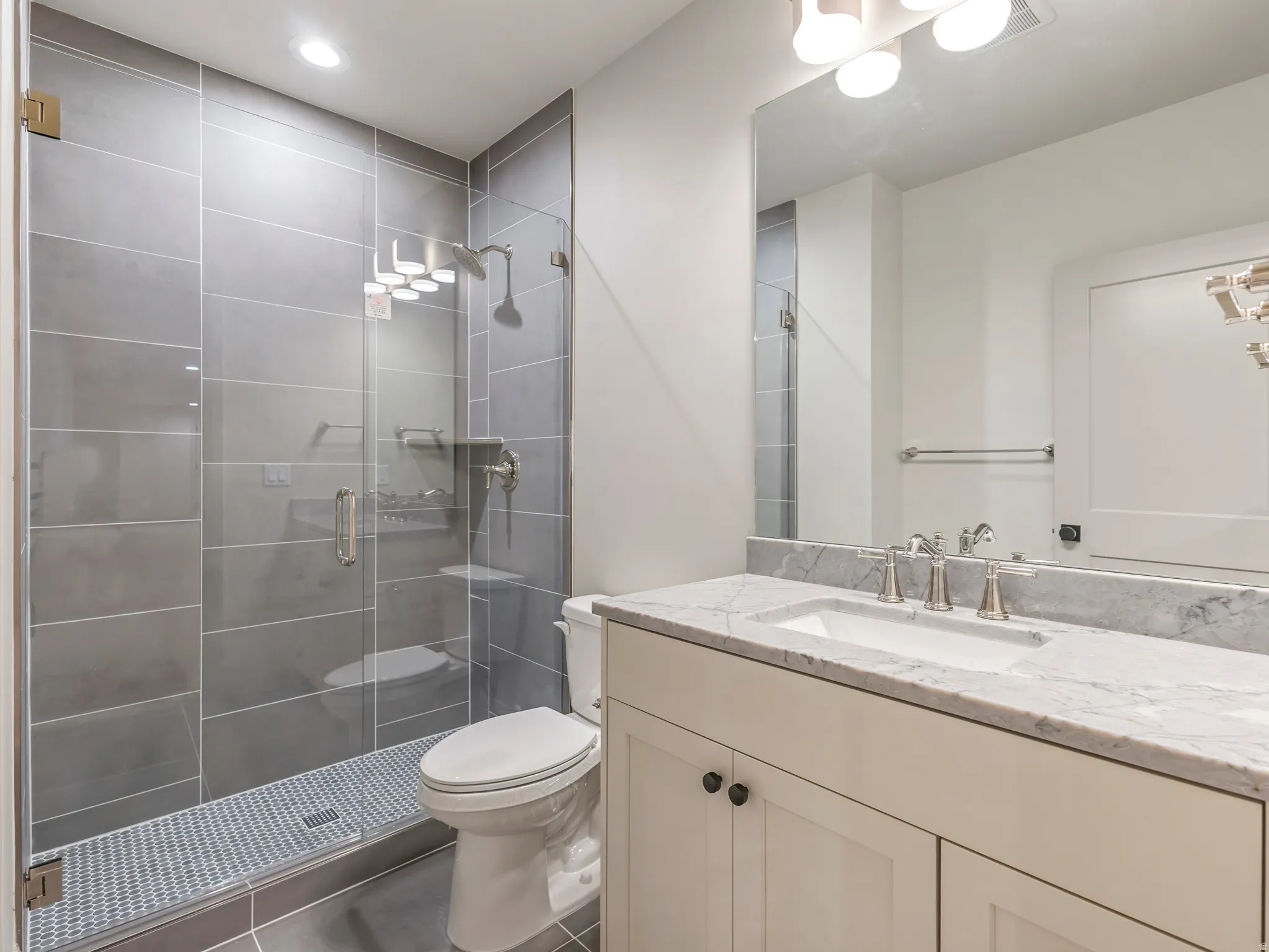 Bathroom with vanity, a stall shower, recessed lighting, and tile patterned floors