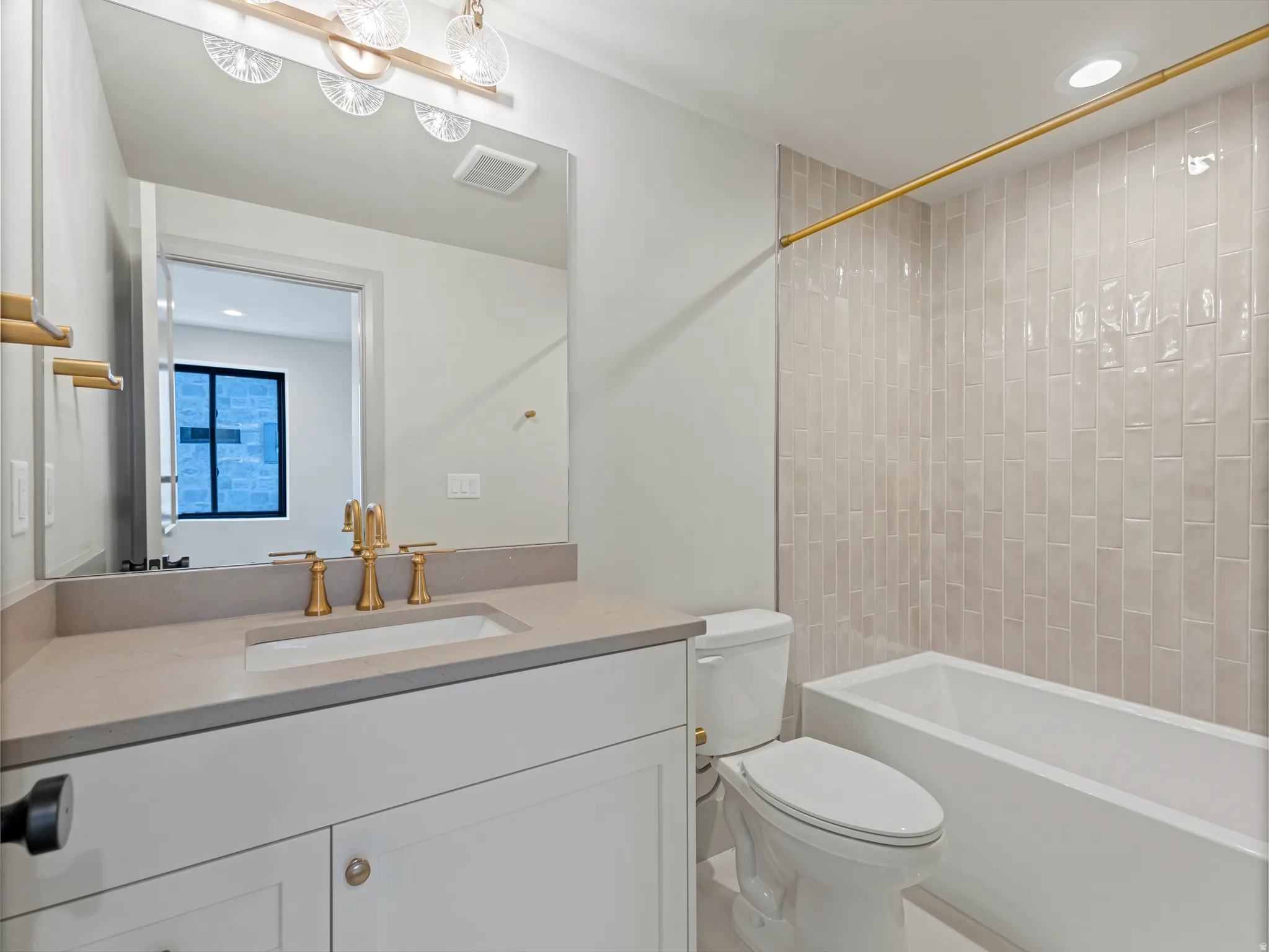 Bathroom with recessed lighting, vanity, and bathing tub / shower combination