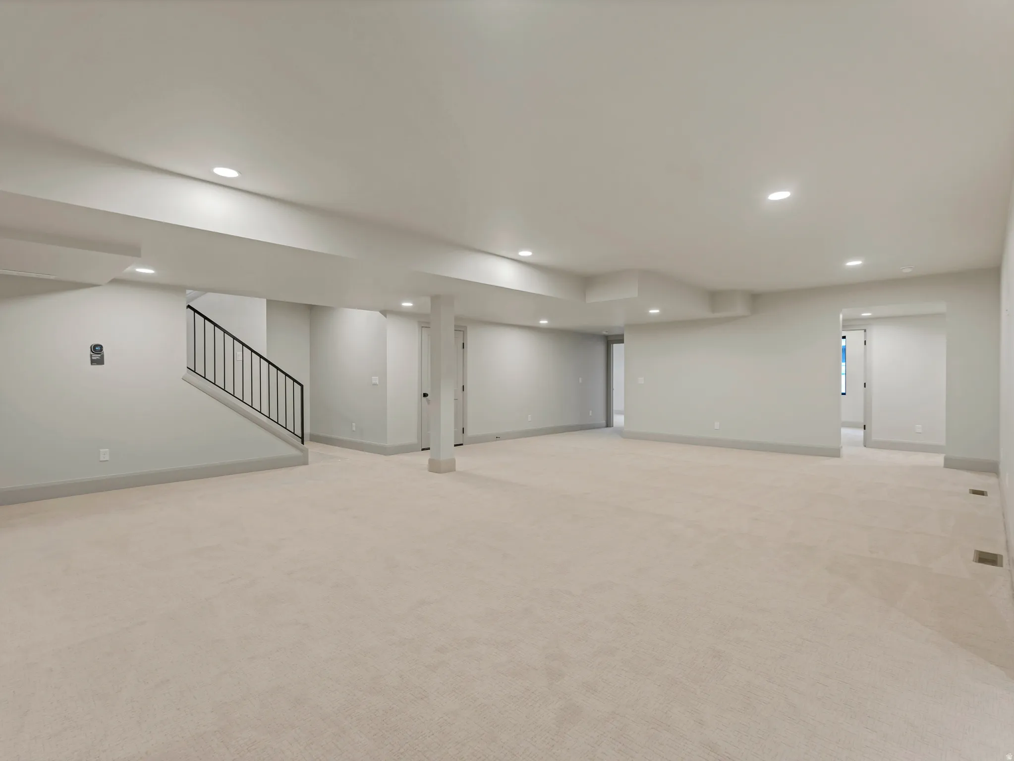 Finished basement featuring light colored carpet and recessed lighting