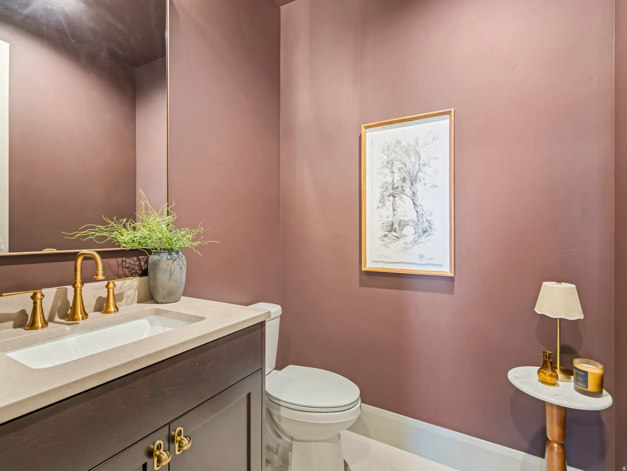 Half bathroom with vanity and toilet