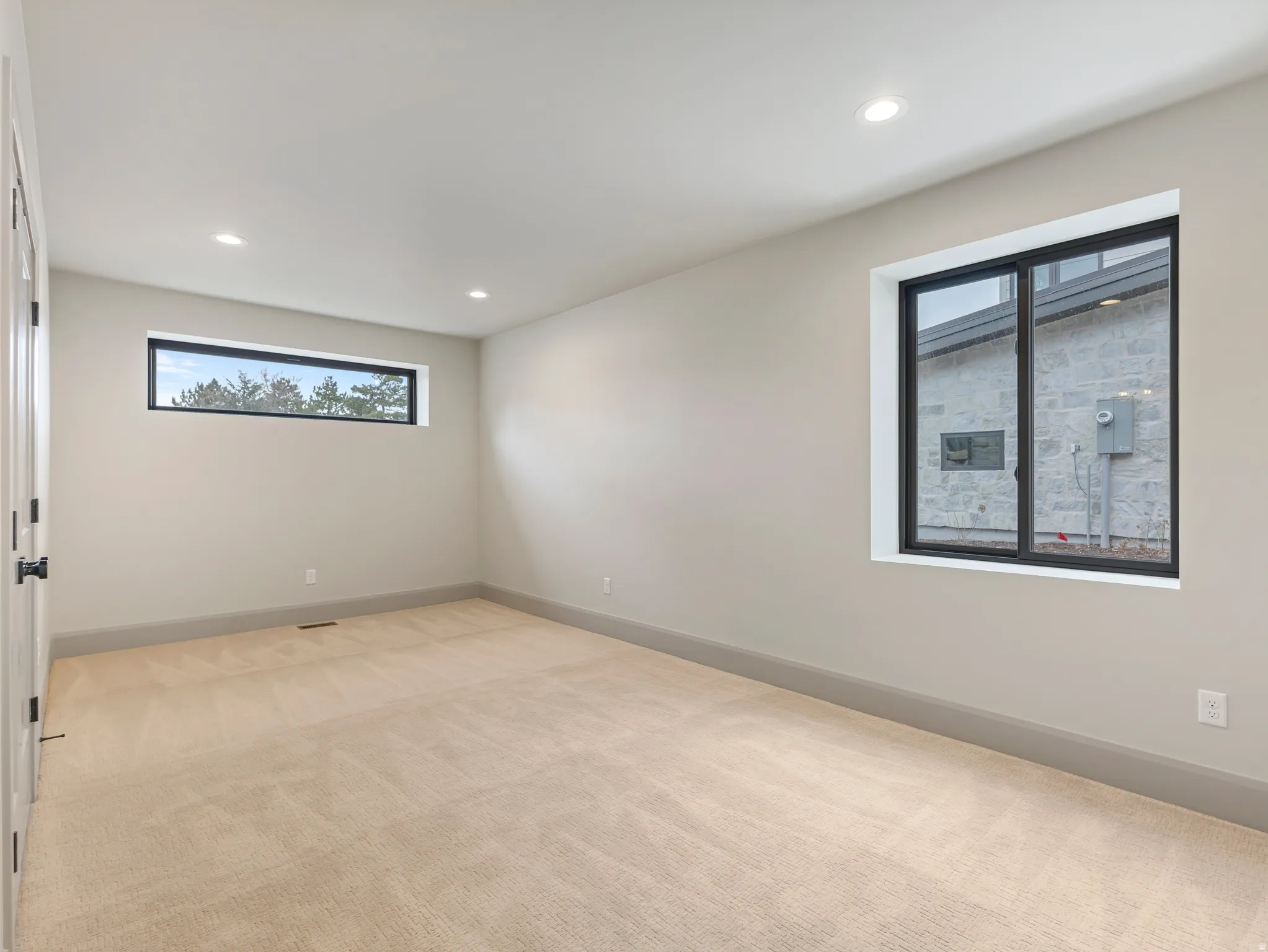 Unfurnished room featuring light carpet and recessed lighting