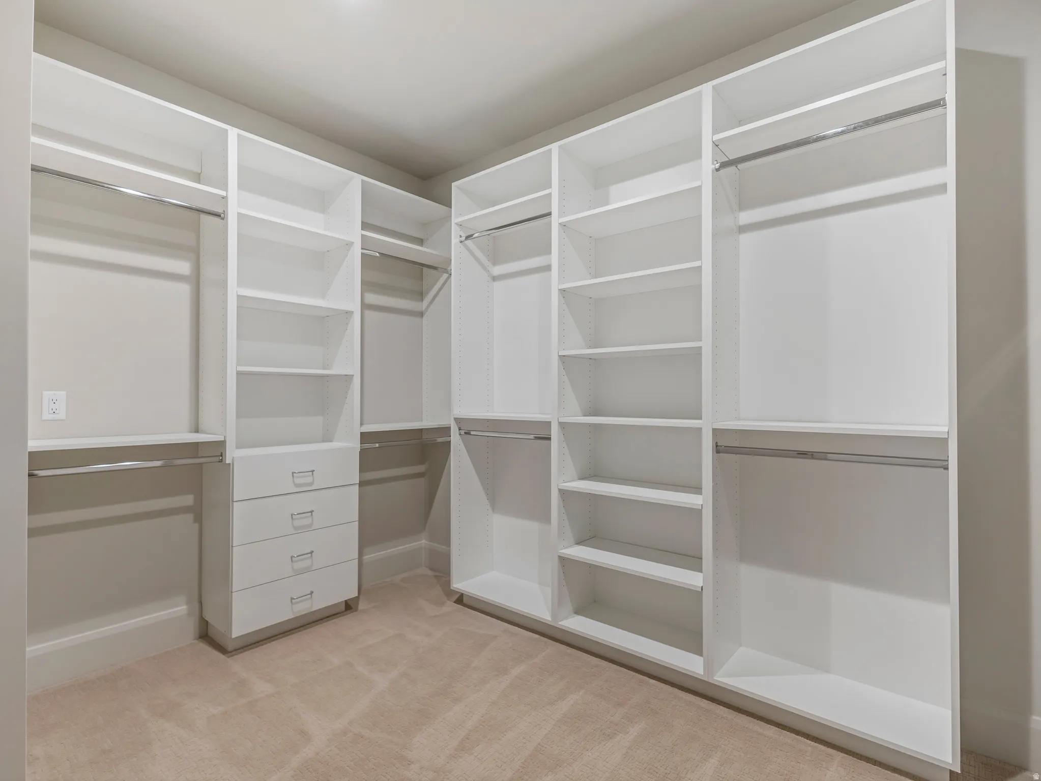 Walk in closet featuring light carpet