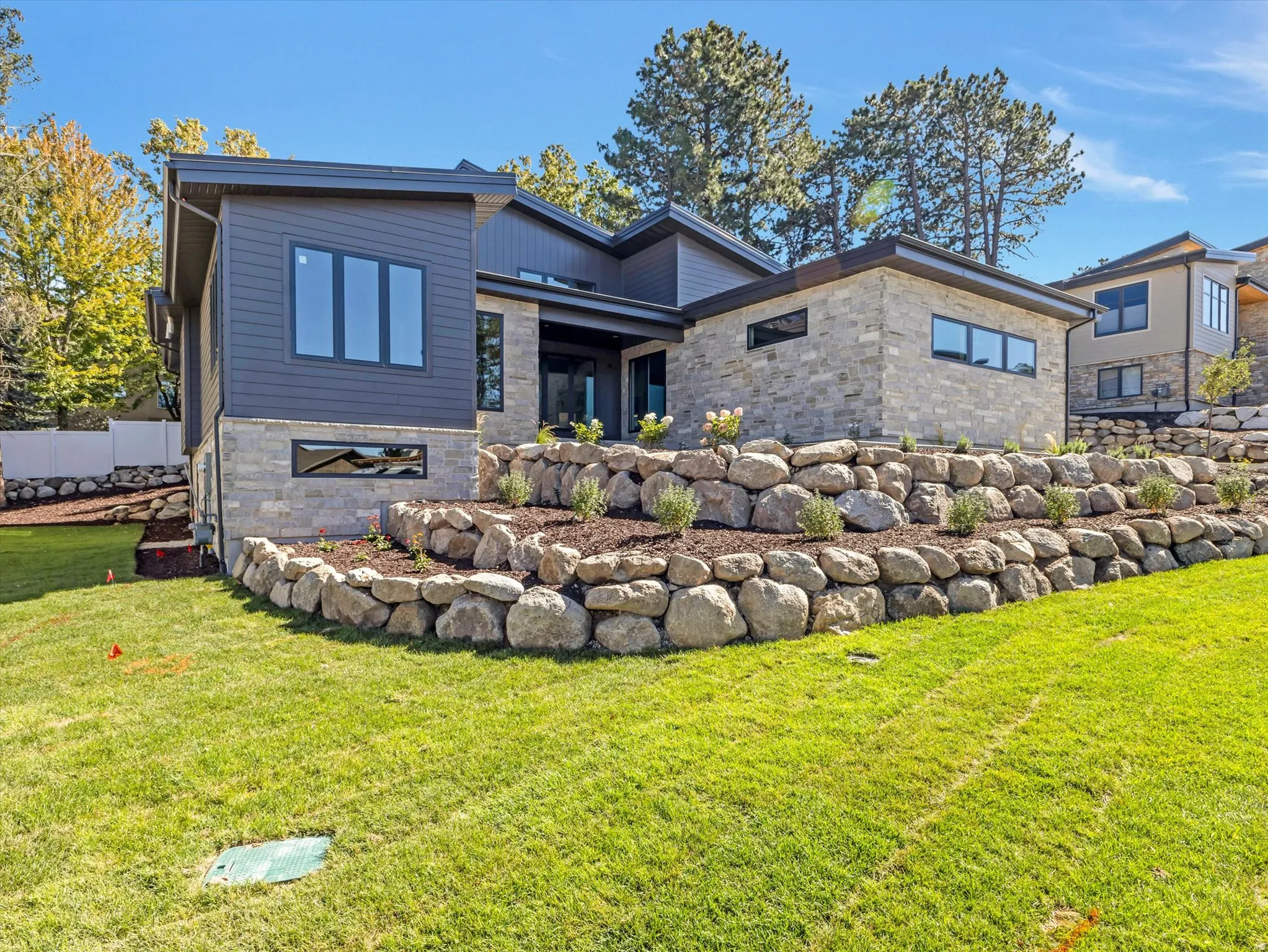Rear view of house featuring stone siding