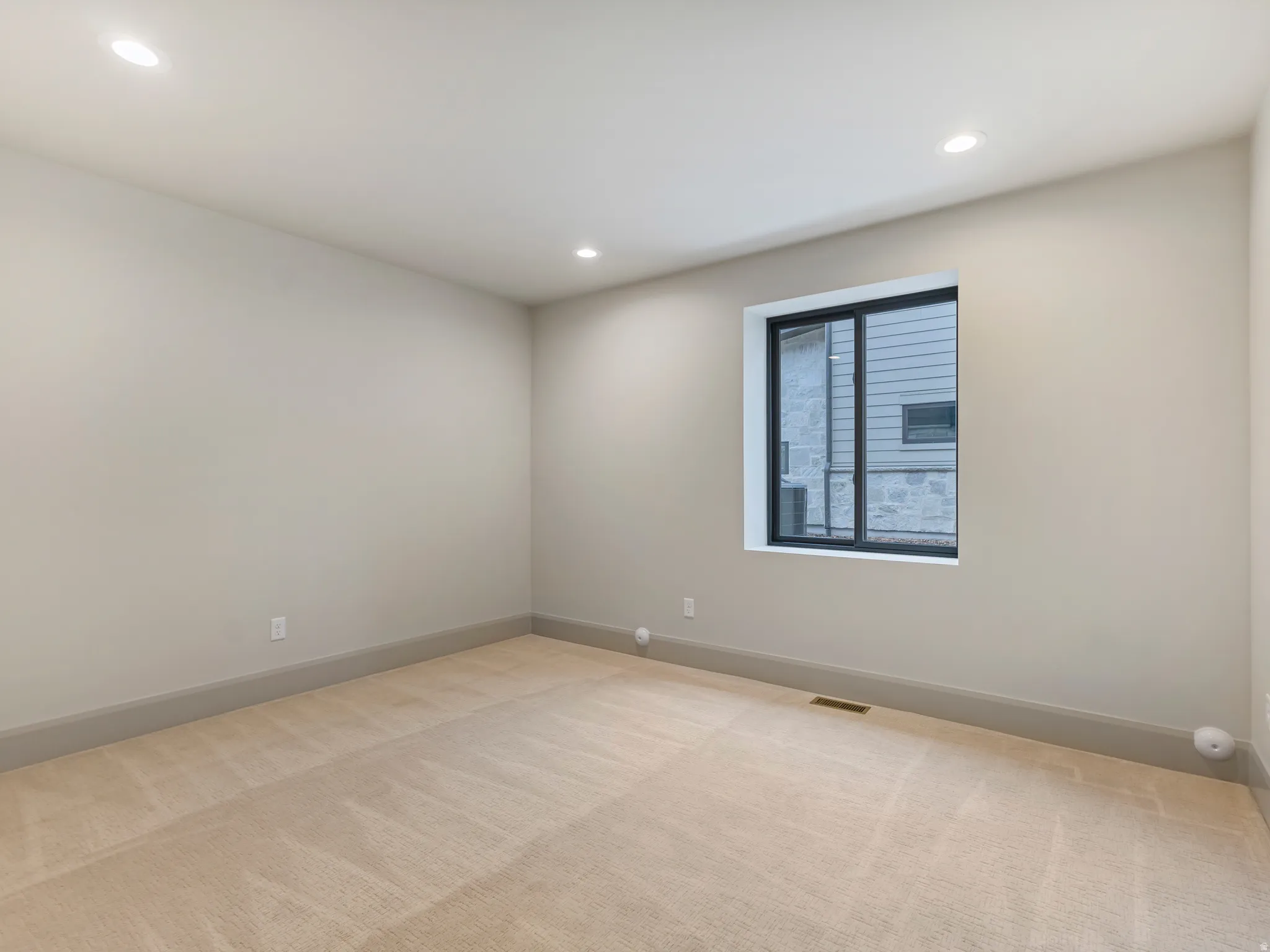 Unfurnished room featuring light colored carpet and recessed lighting