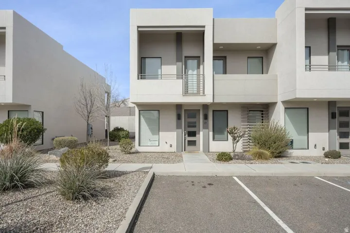 View of building exterior with uncovered parking