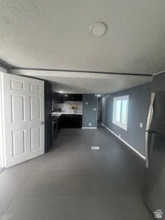 Unfurnished living room featuring a textured ceiling