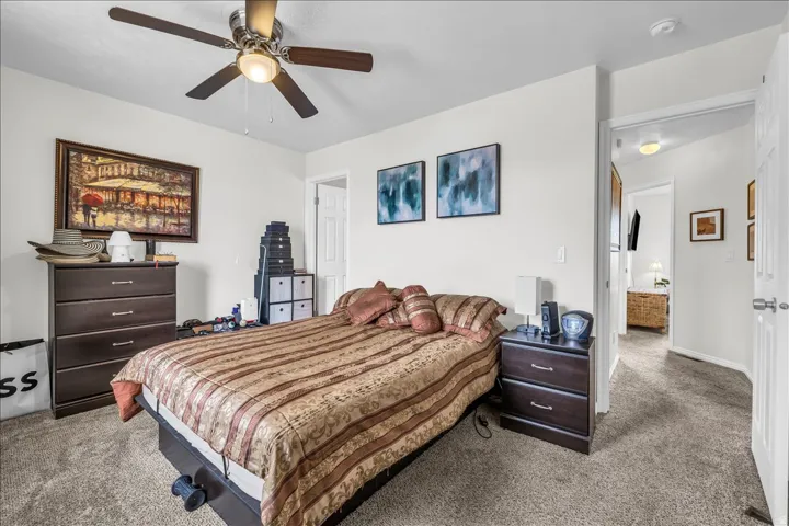 Bedroom featuring light carpet and a ceiling fan