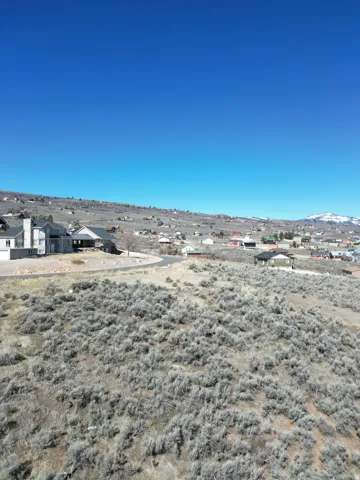 Water view with nearby suburban area and a mountain backdrop