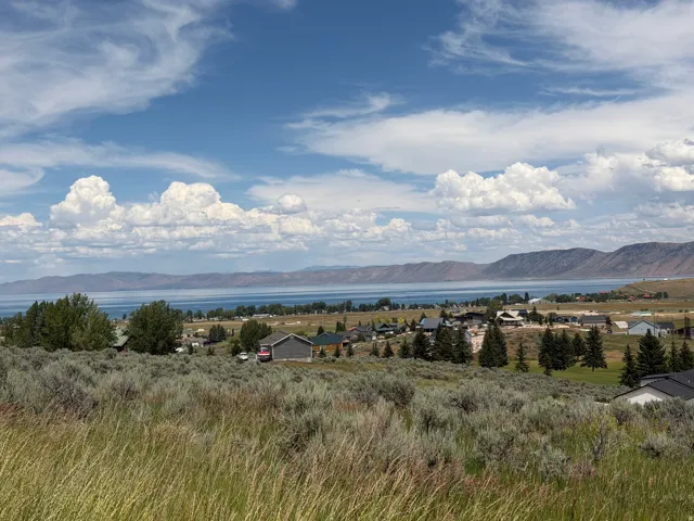 Expansive landscape featuring a large body of water bordered by distant mountains
