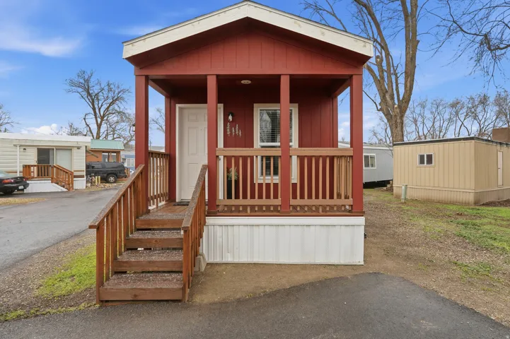 Manufactured / mobile home featuring a porch and board and batten siding