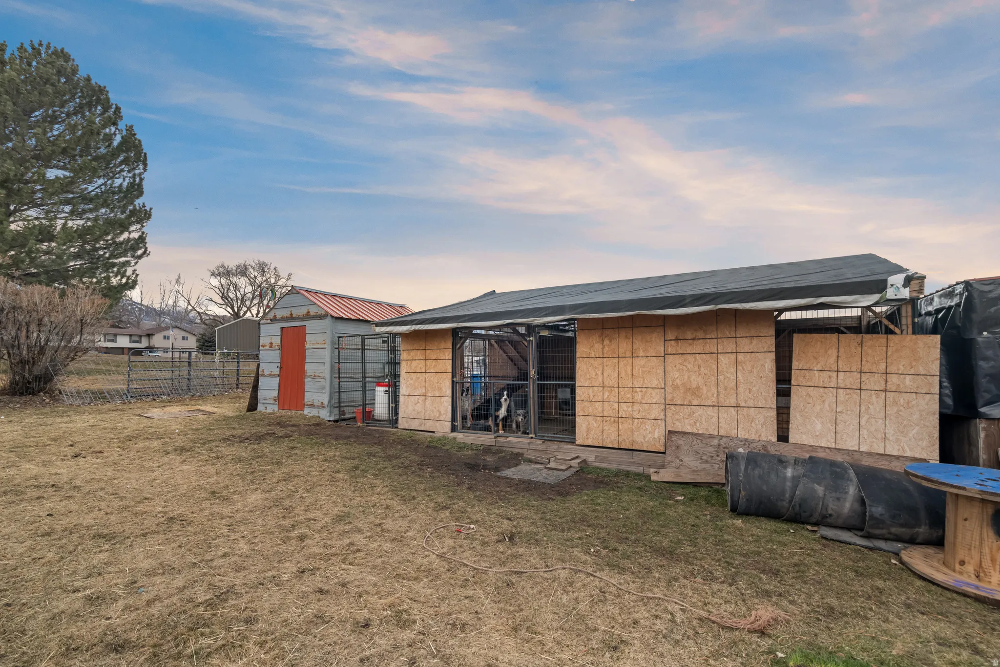 Back of house with an outbuilding and concrete block siding