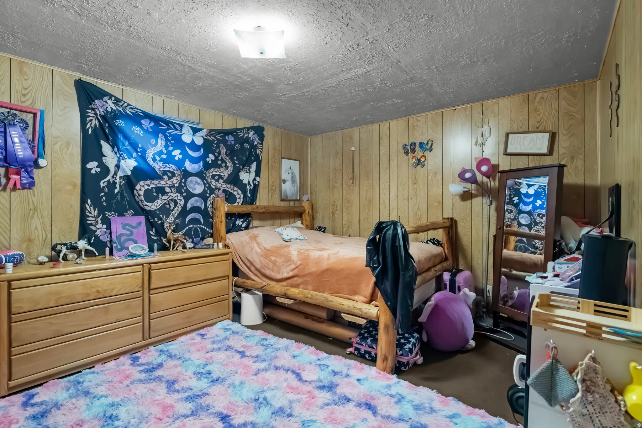 Bedroom featuring wooden walls