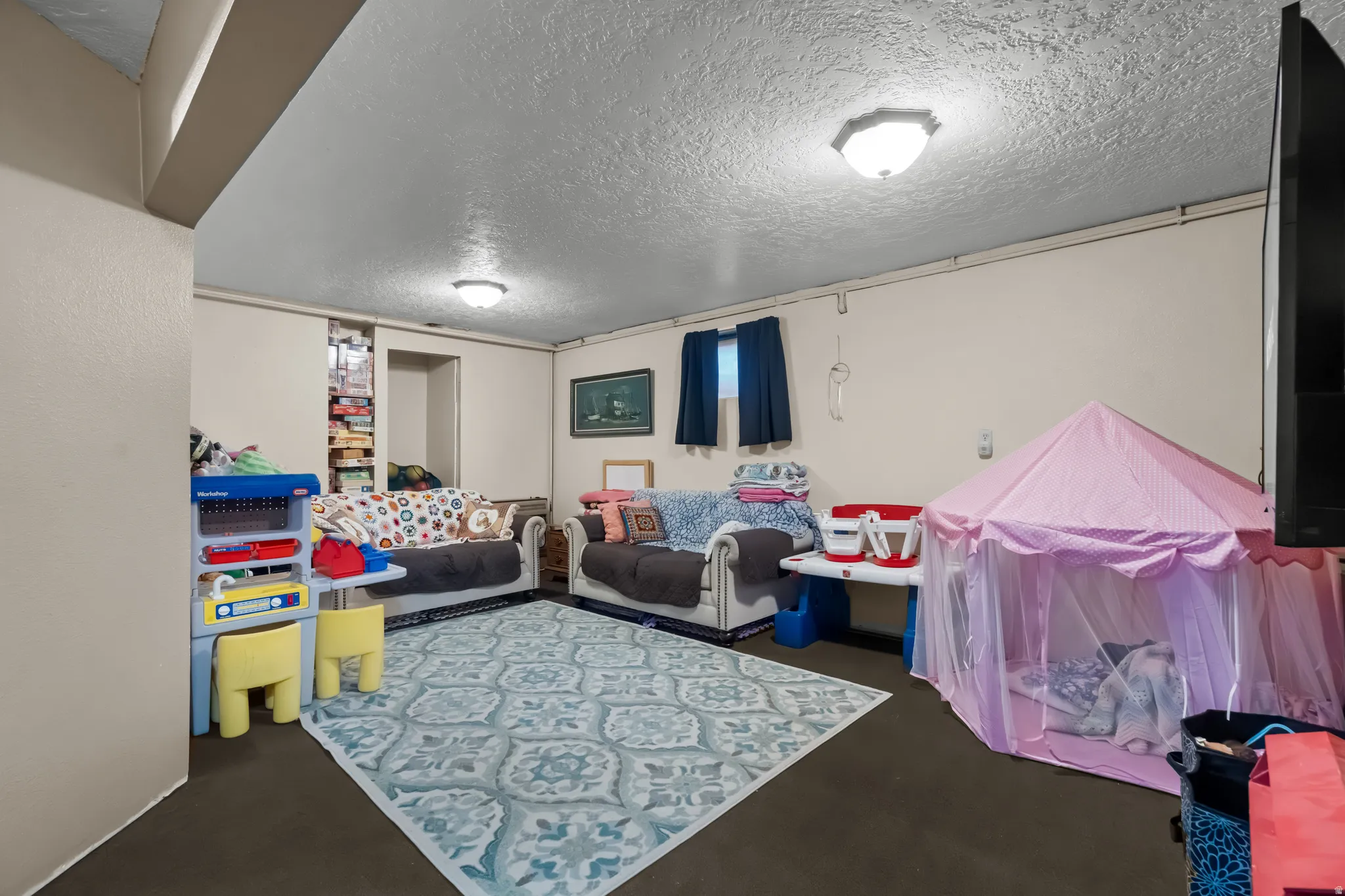 Game room with a textured ceiling