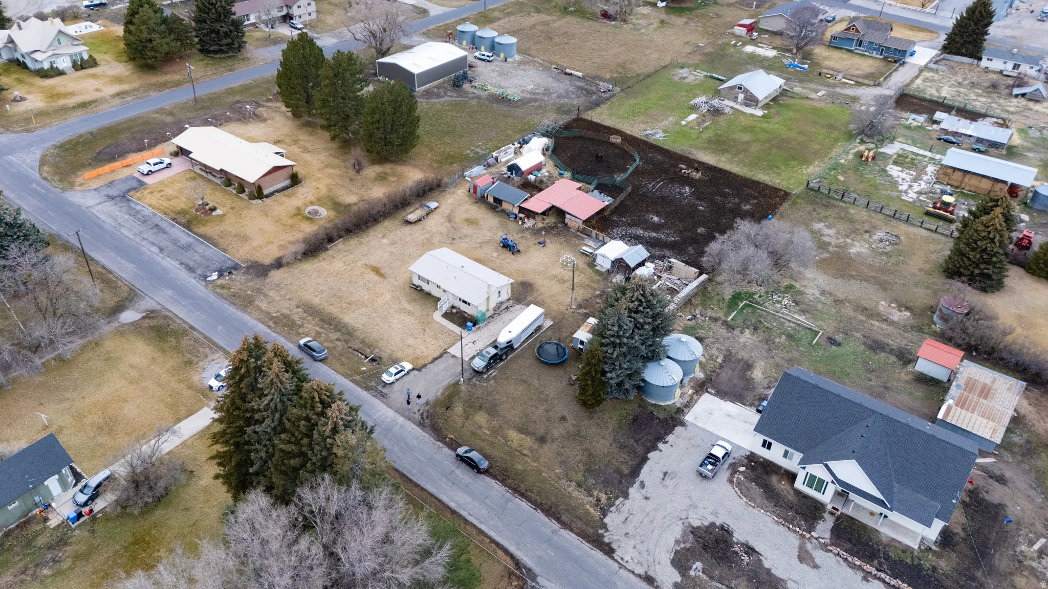 Aerial view of property and surrounding area with nearby suburban area