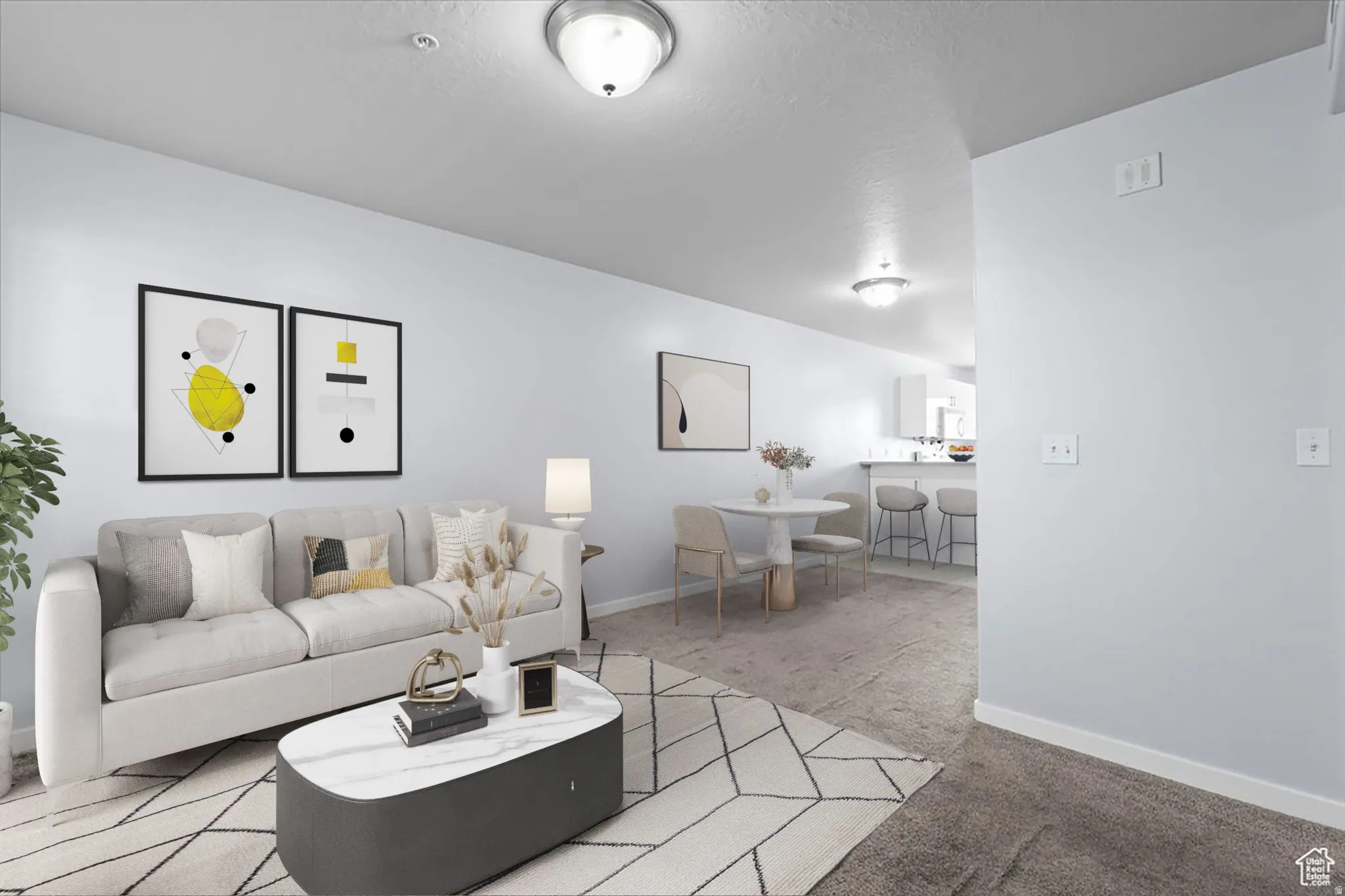 Living area featuring light carpet and baseboards