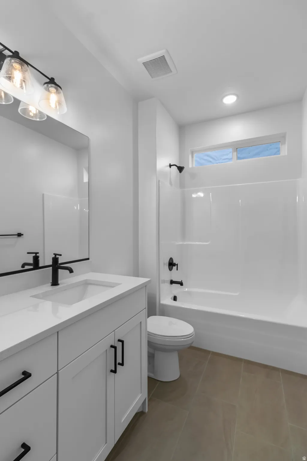 Full bathroom with vanity, bathing tub / shower combination, light tile patterned floors, and recessed lighting