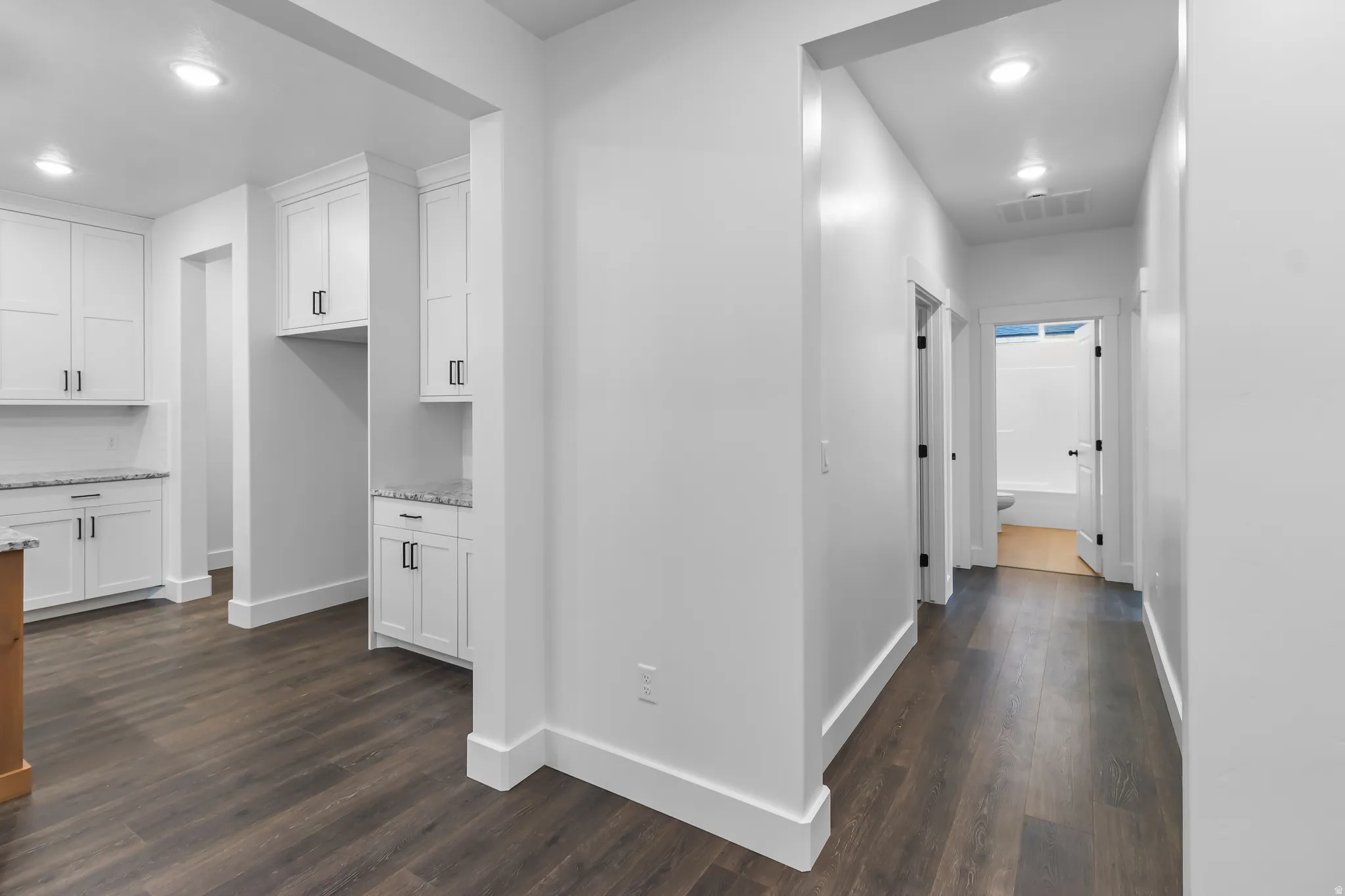 Hall with recessed lighting and dark wood finished floors
