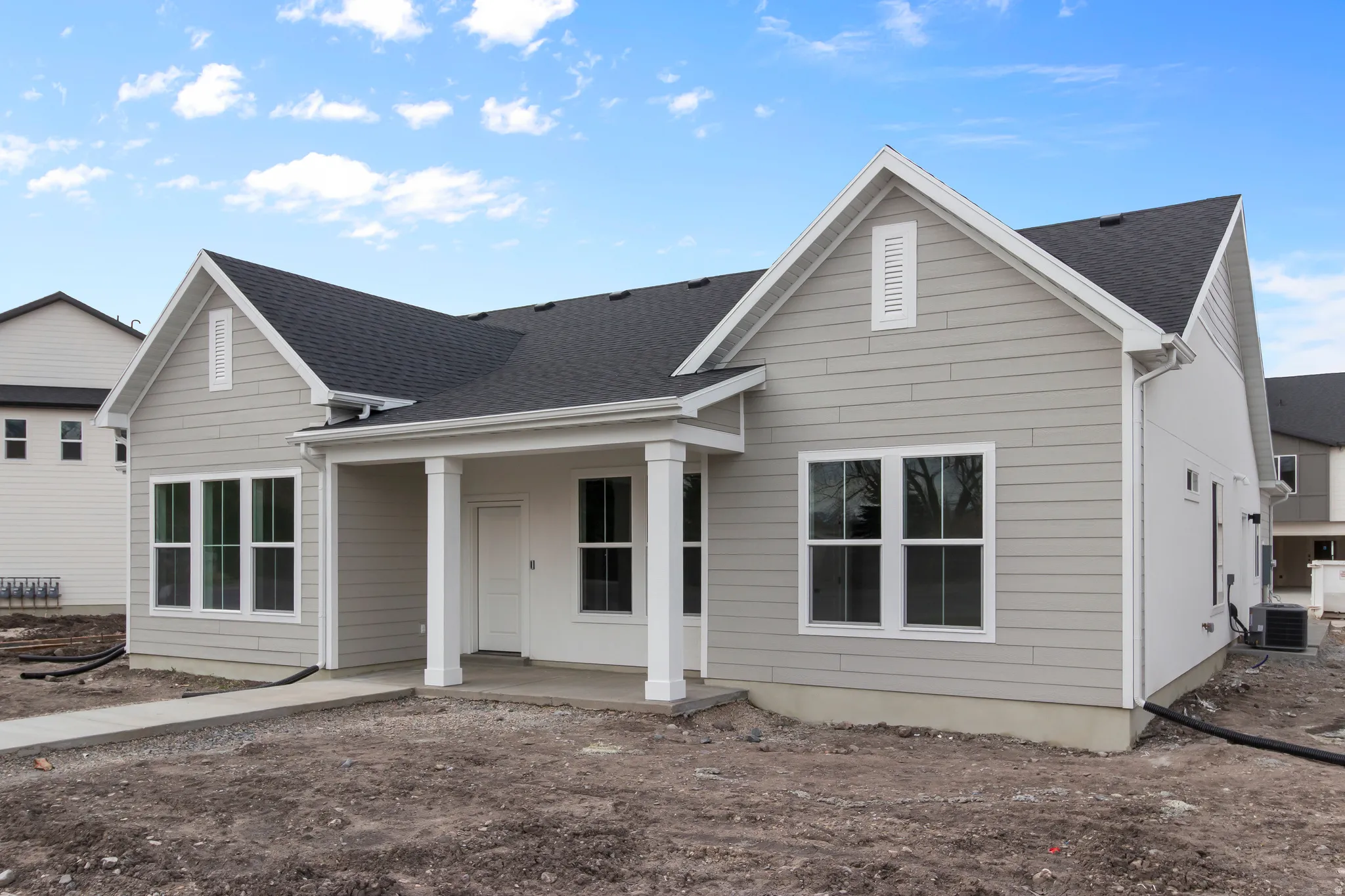 View of front of property with a shingled roof and a patio