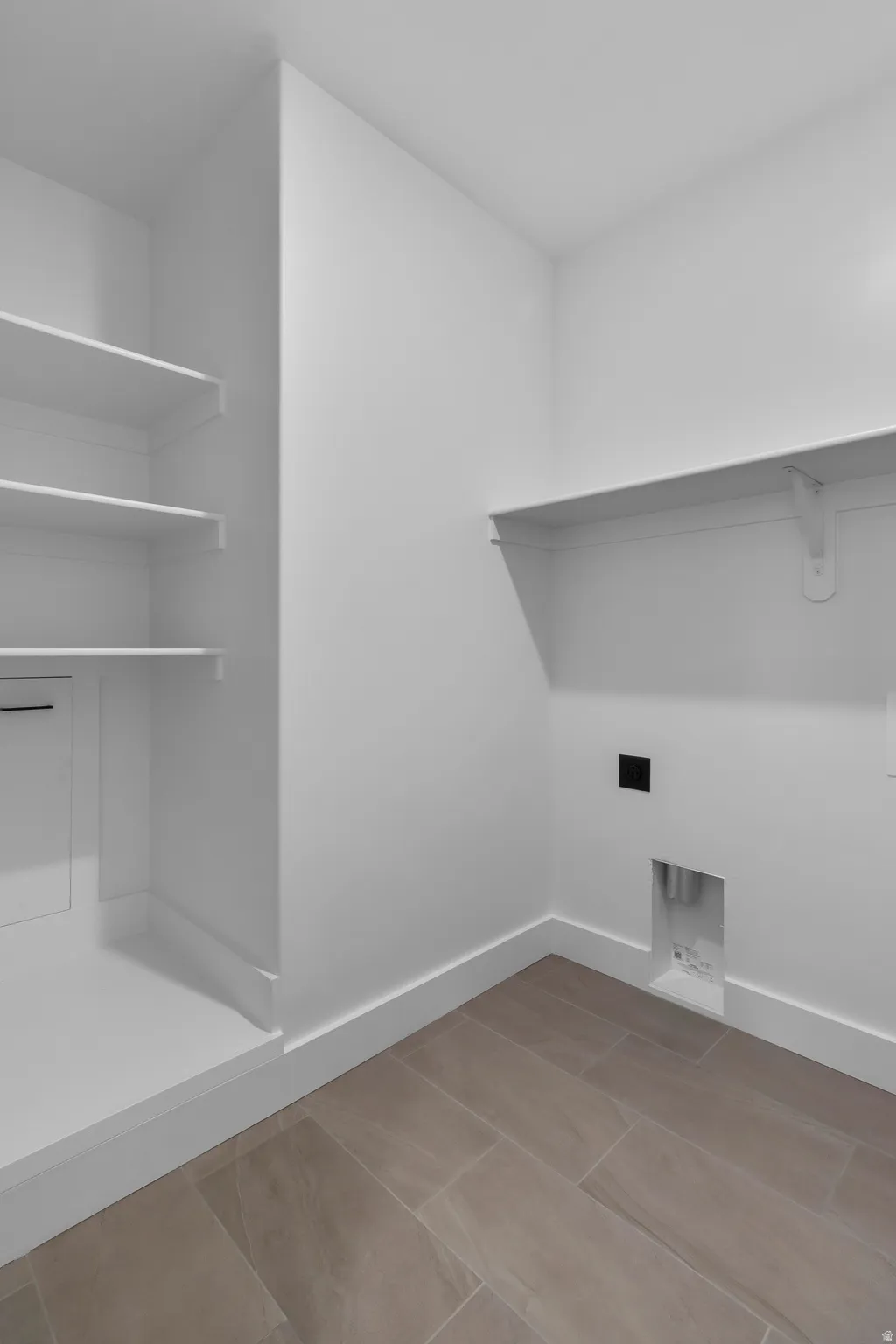 Laundry room with baseboards and hookup for an electric dryer