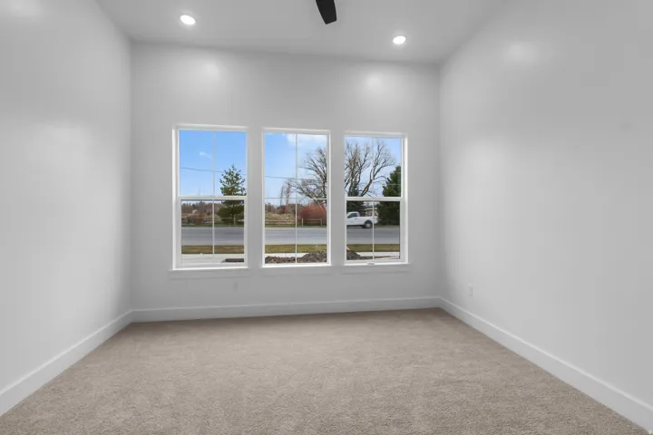 Unfurnished room with light colored carpet, a ceiling fan, and recessed lighting