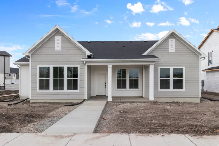 Single story home with a shingled roof and a porch