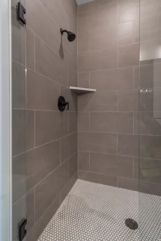 Full bathroom featuring tiled shower