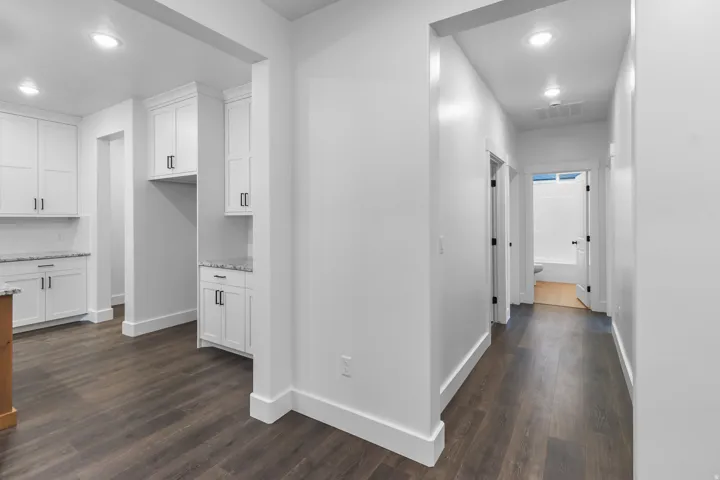 Hall with recessed lighting and dark wood finished floors