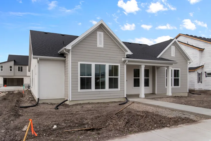 View of front of property featuring roof with shingles and a porch