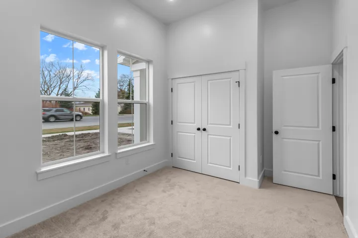 Unfurnished bedroom featuring light colored carpet and a closet