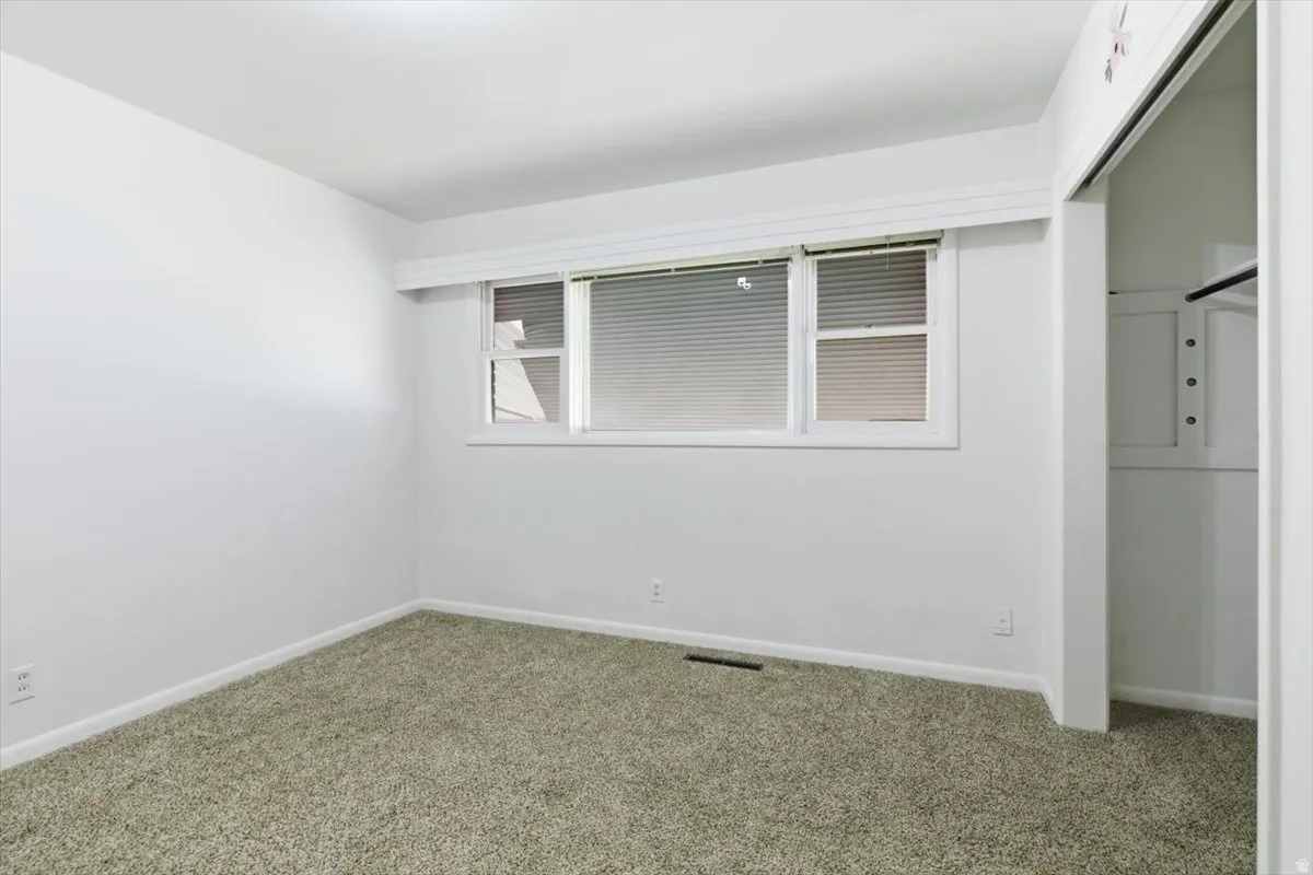 Unfurnished bedroom with a closet and carpet