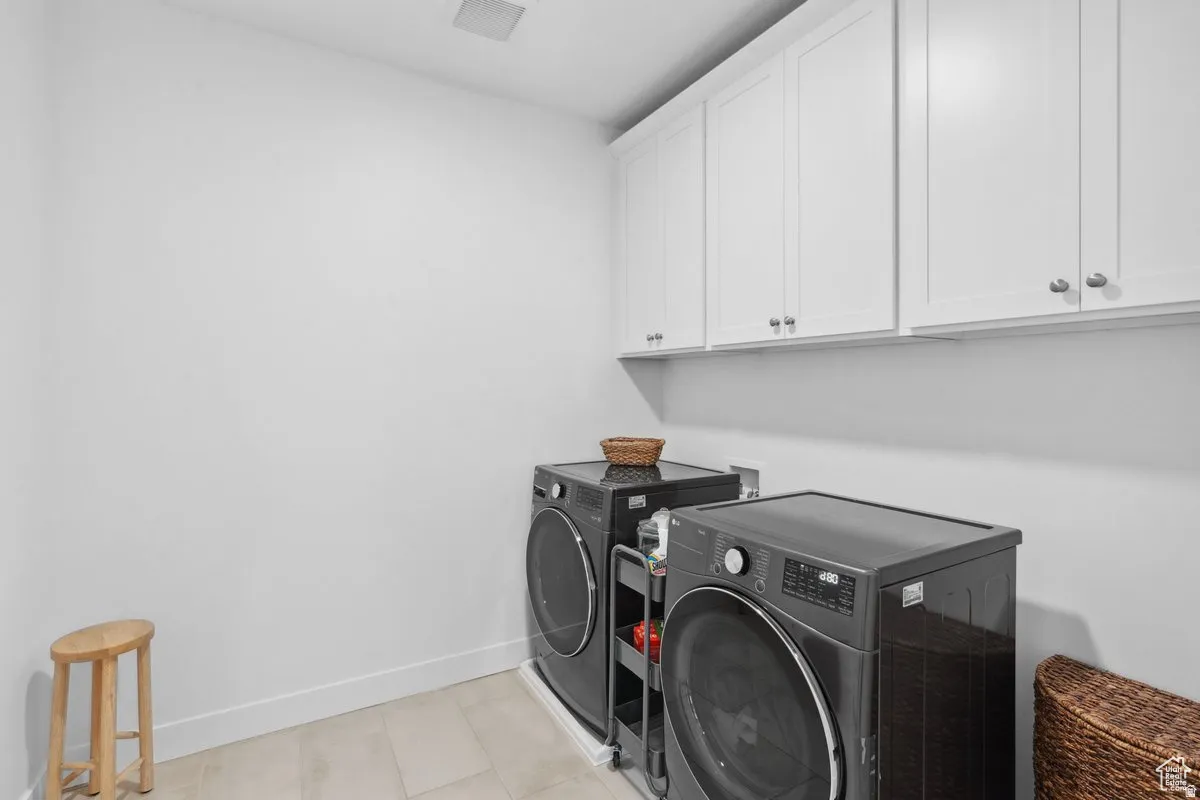 Laundry room with cabinet space and washing machine and dryer