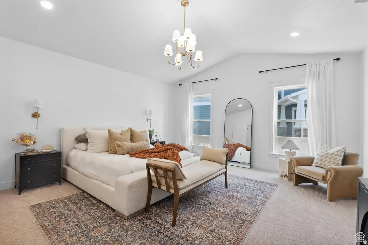 Bedroom featuring light colored carpet and suspended lighting