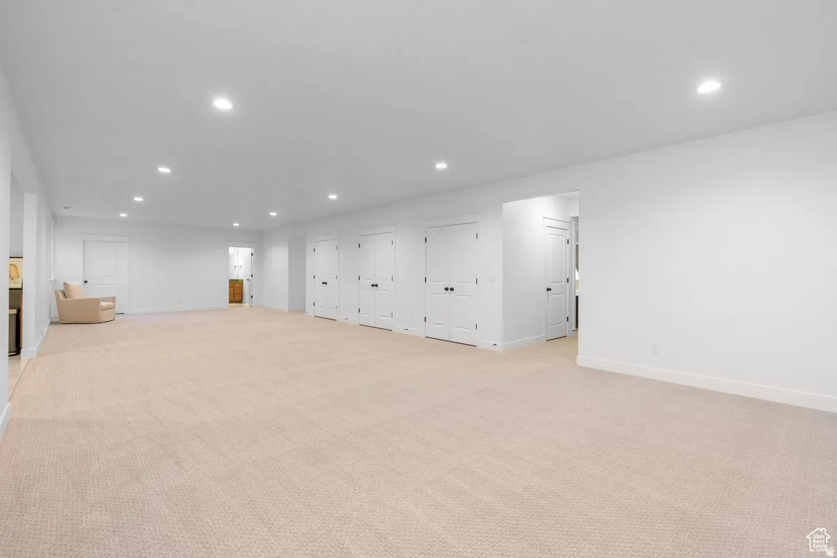 Spare room featuring light colored carpet and recessed lighting