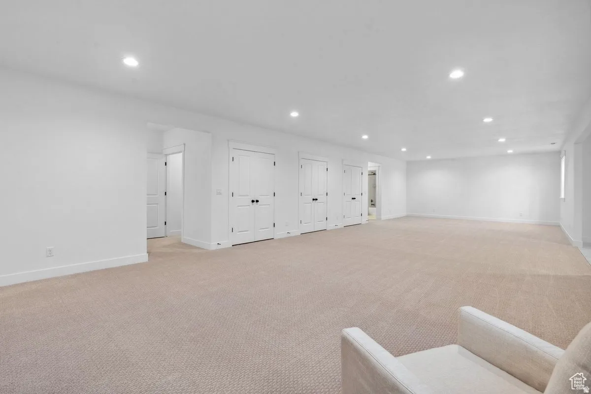 Basement featuring recessed lighting and light carpet