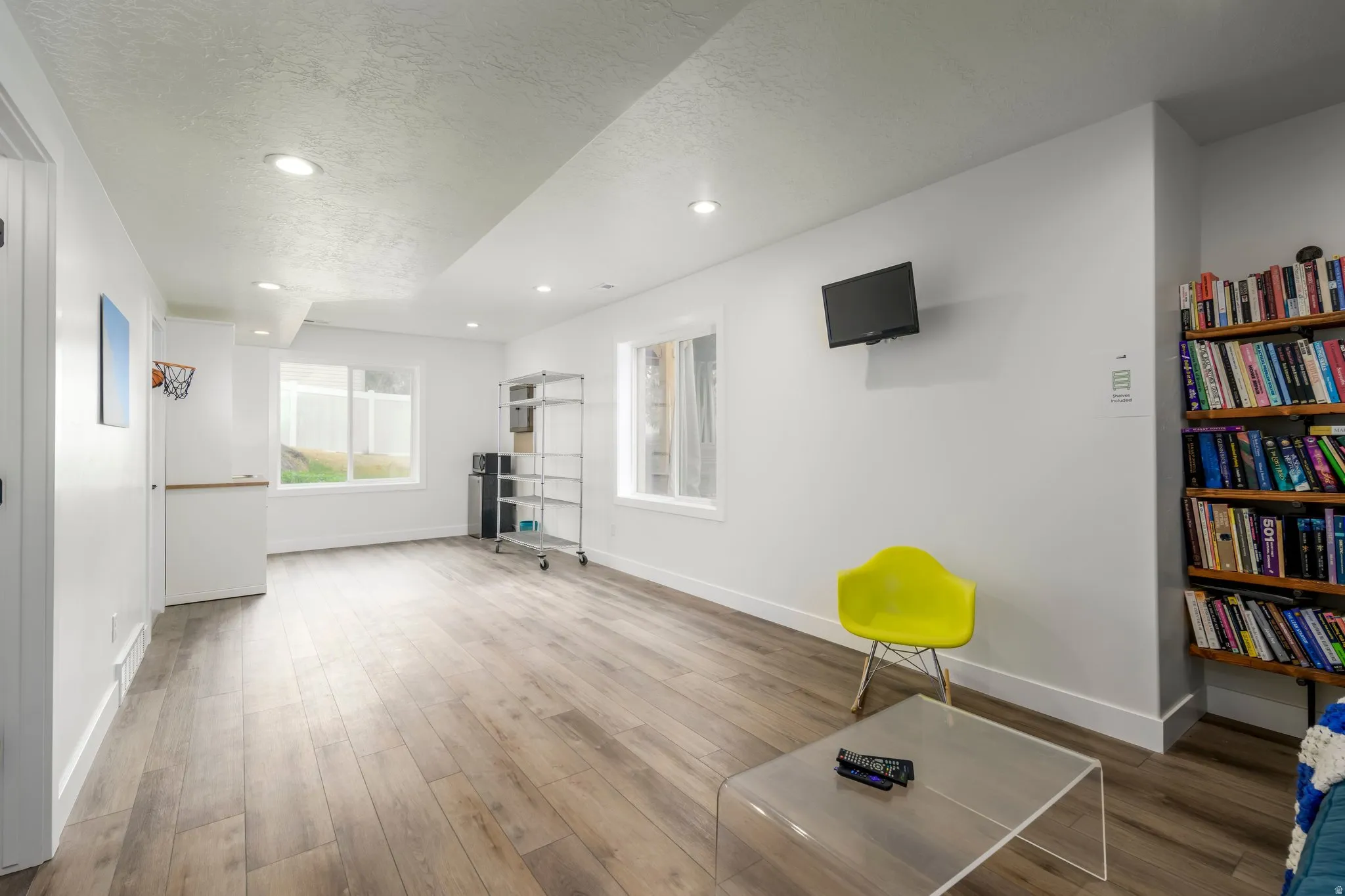 Sitting room featuring a textured ceiling, wood finished floors, and recessed lighting