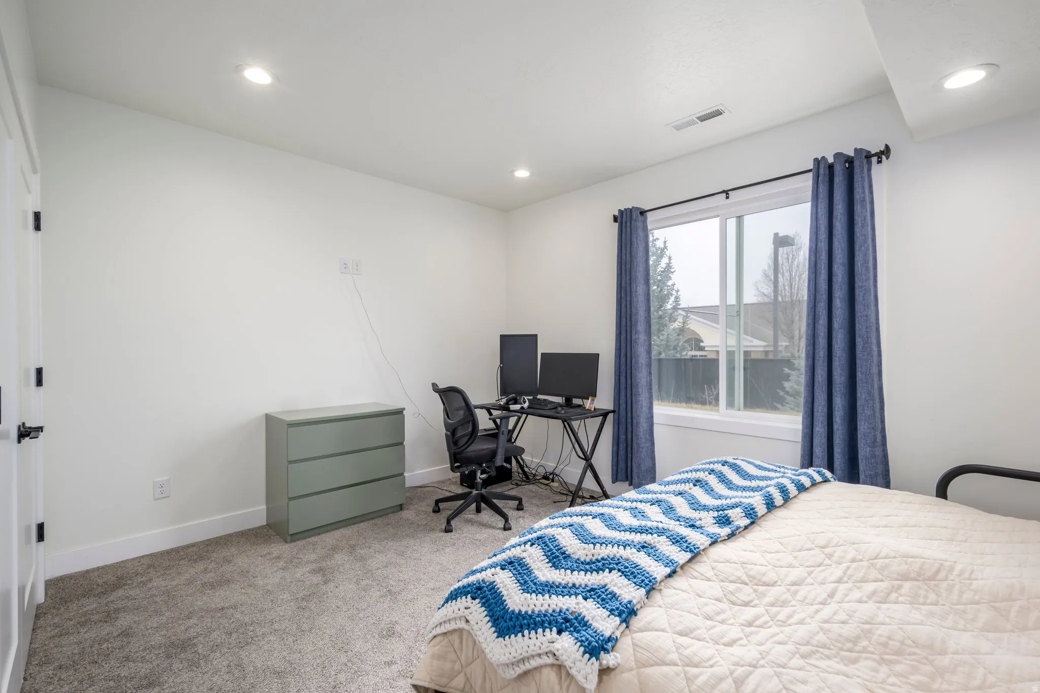 Bedroom featuring carpet, a desk, and recessed lighting