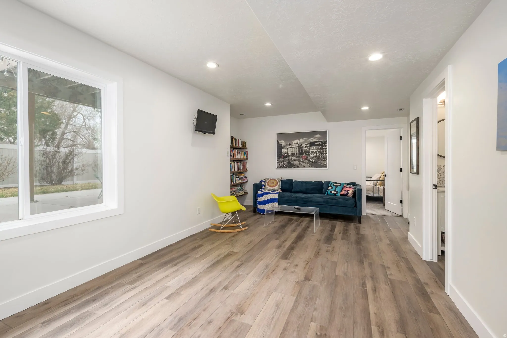 Sitting room with light wood-style flooring and recessed lighting