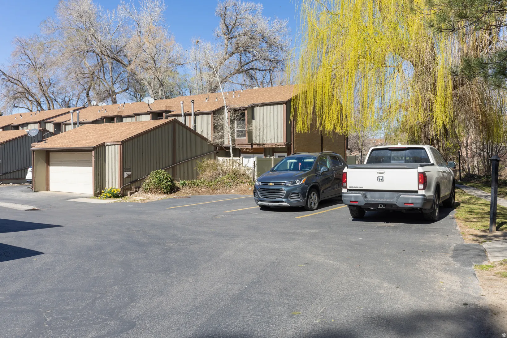 View of front facade with uncovered parking and an outbuilding