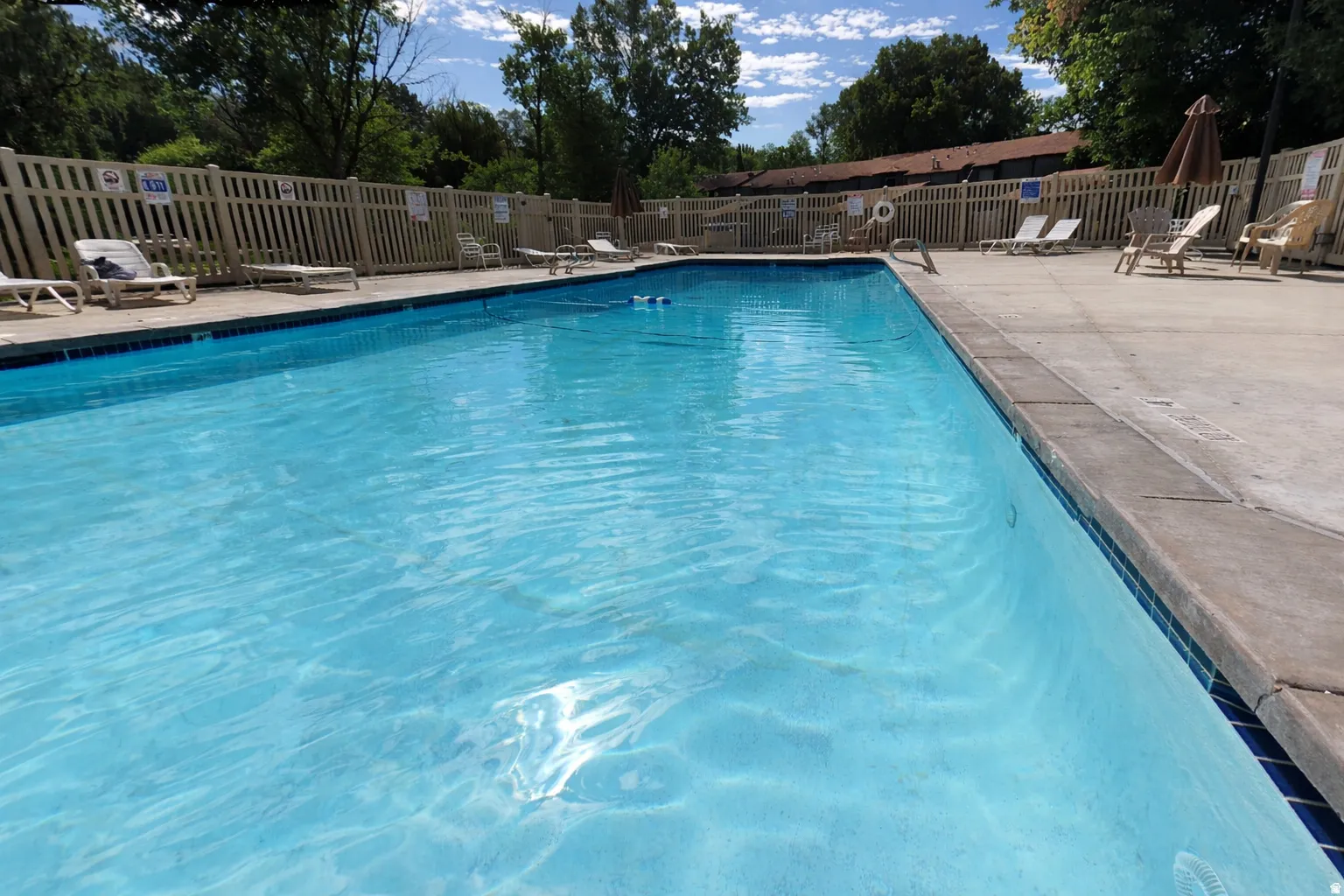 Community pool with a patio