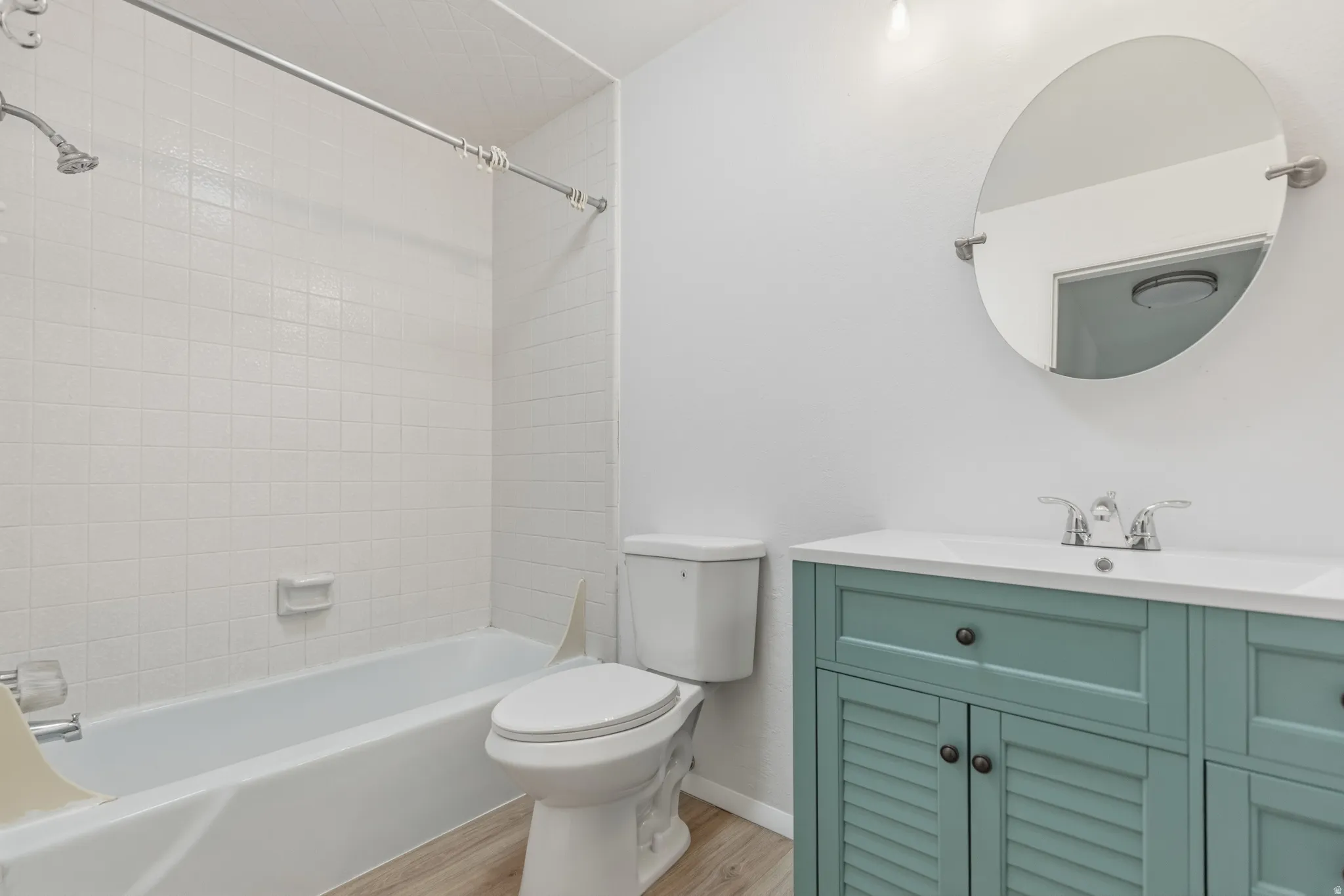 Full bathroom with vanity, shower / bathtub combination, and light wood finished floors