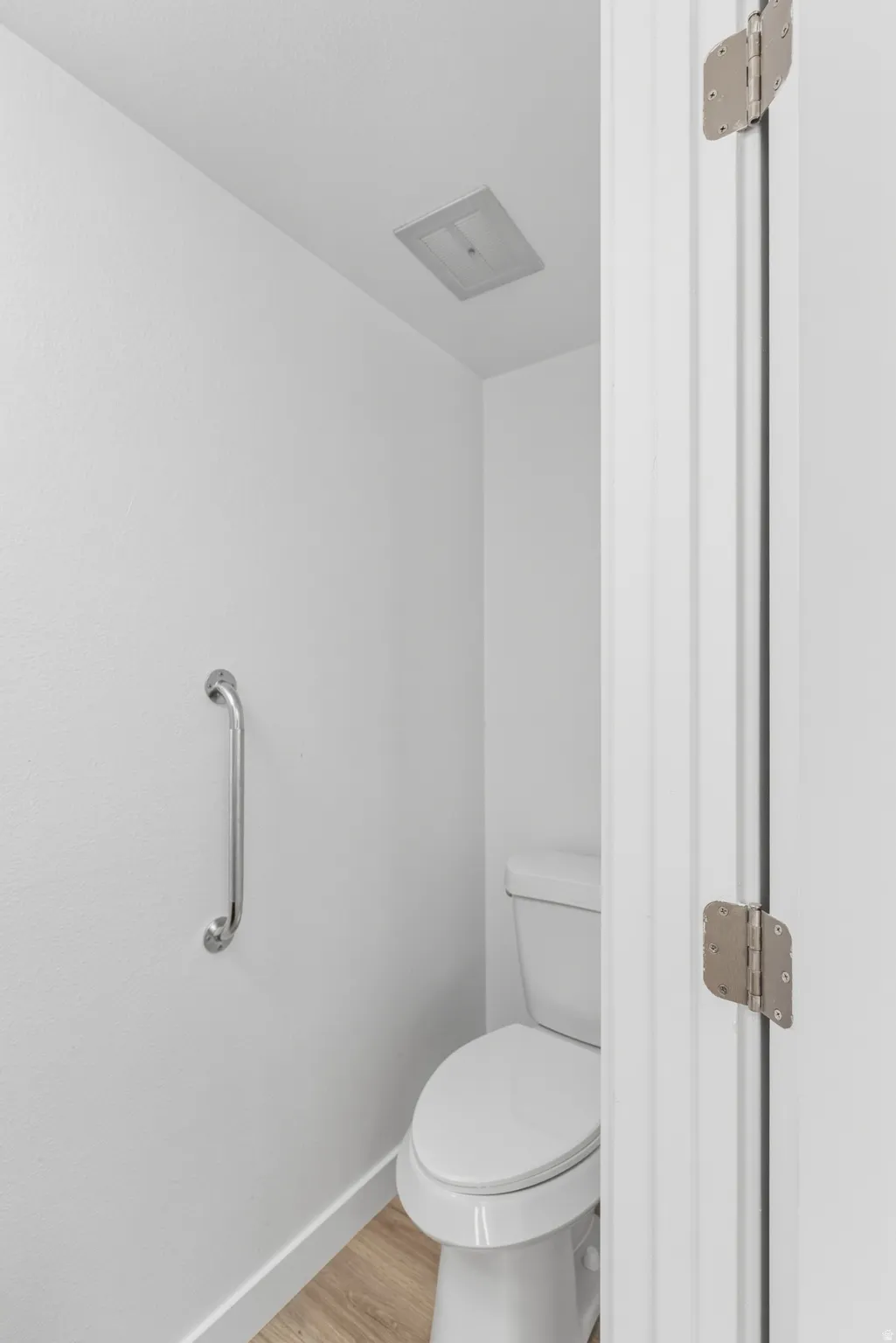 Bathroom with light wood finished floors and baseboards