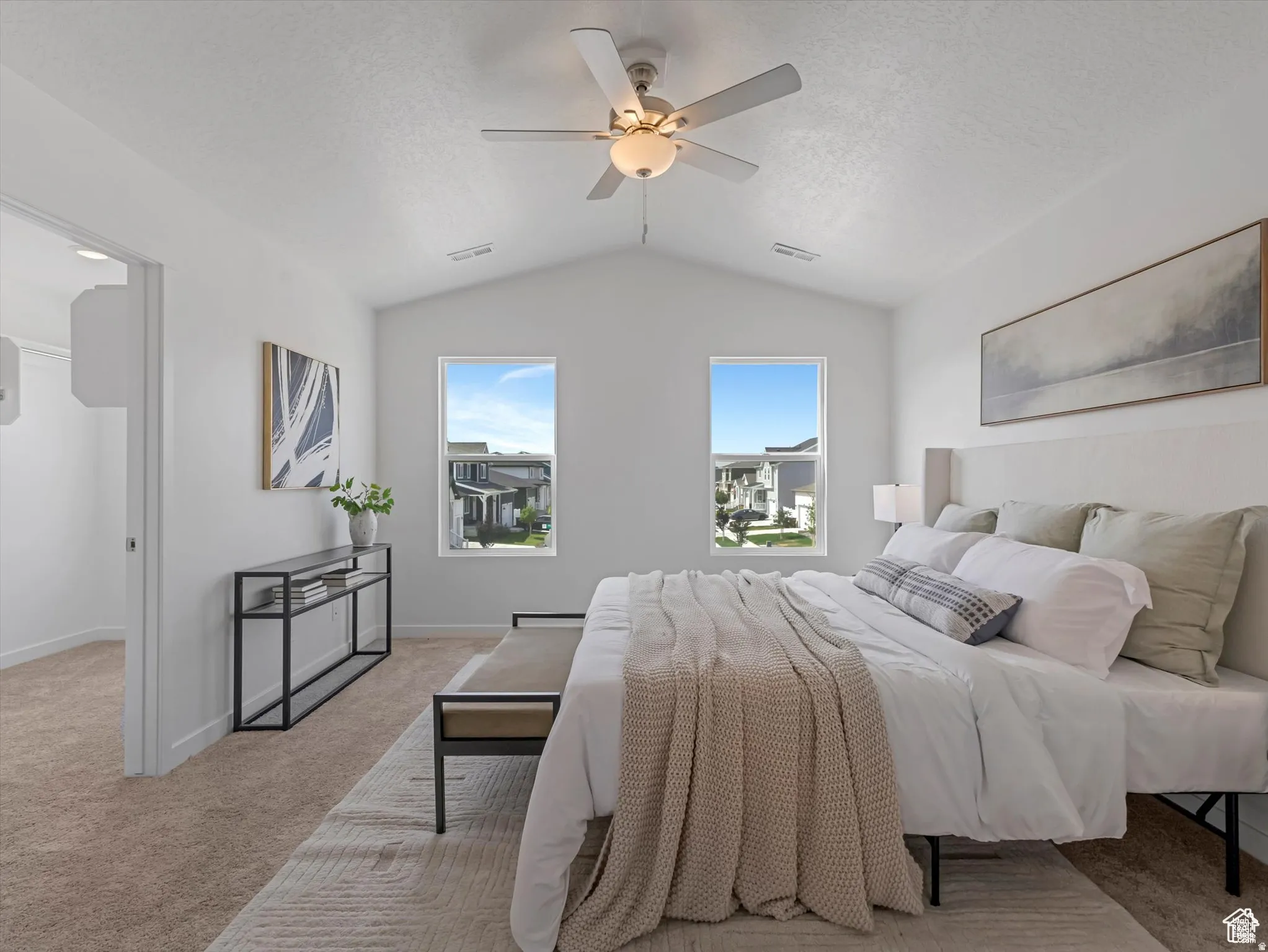 Bedroom featuring light colored carpet, a ceiling fan, and a textured ceiling