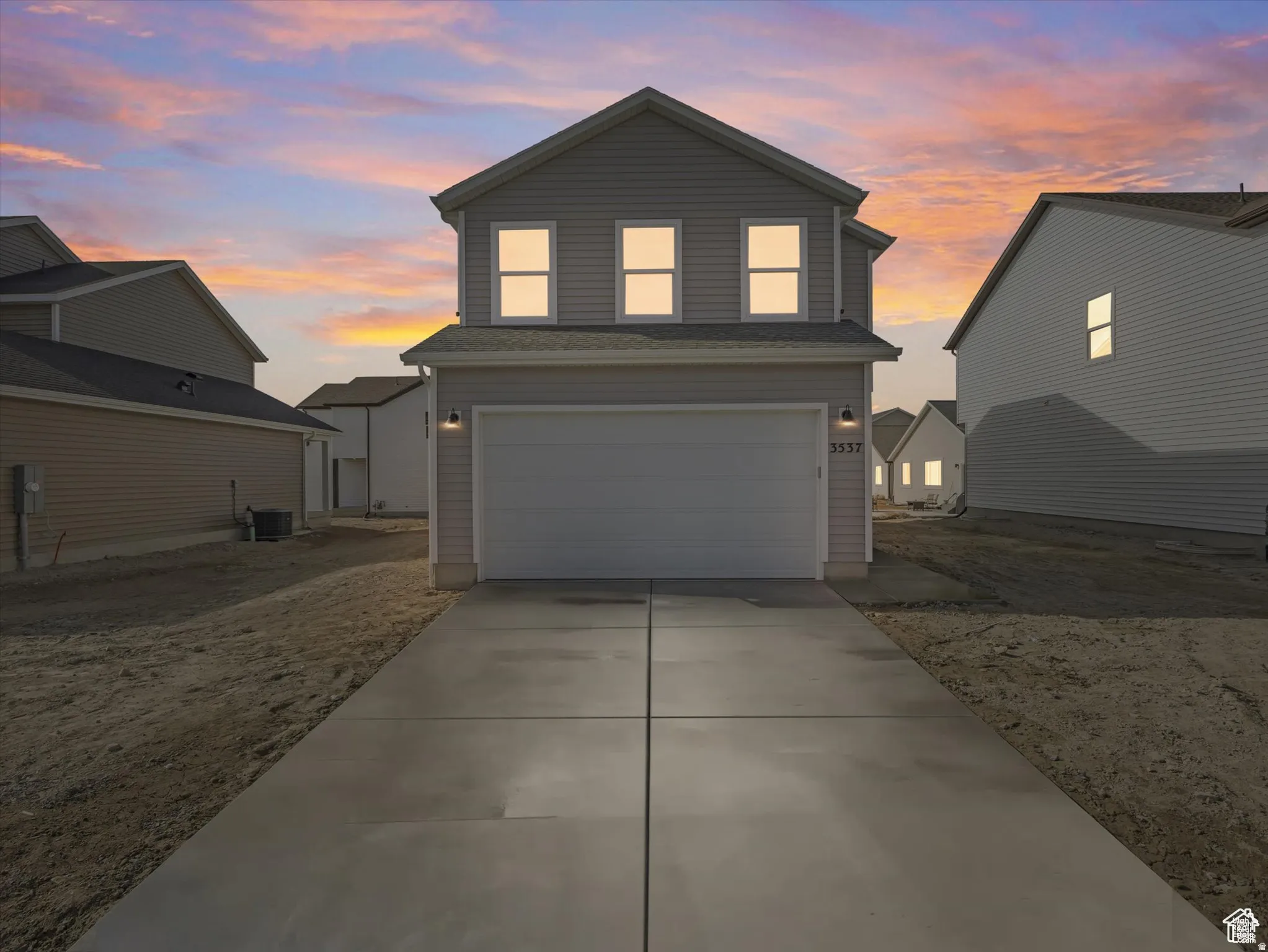 Traditional-style home featuring driveway and a garage