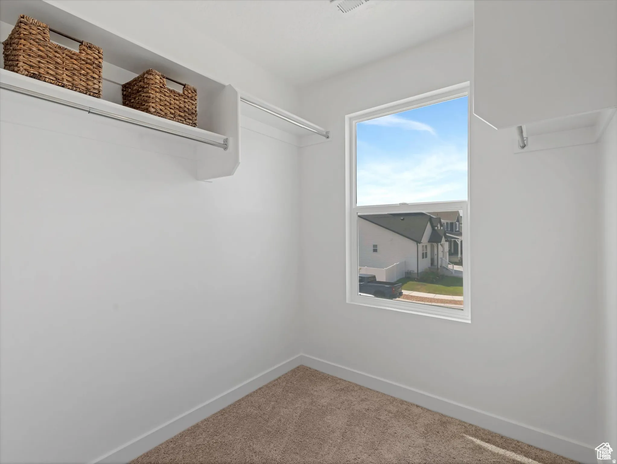 Walk in closet featuring carpet floors