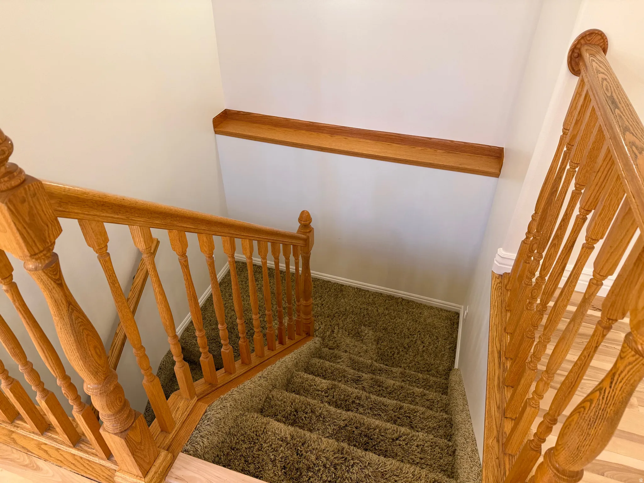 Stairs with landing and decorative trim and baseboards