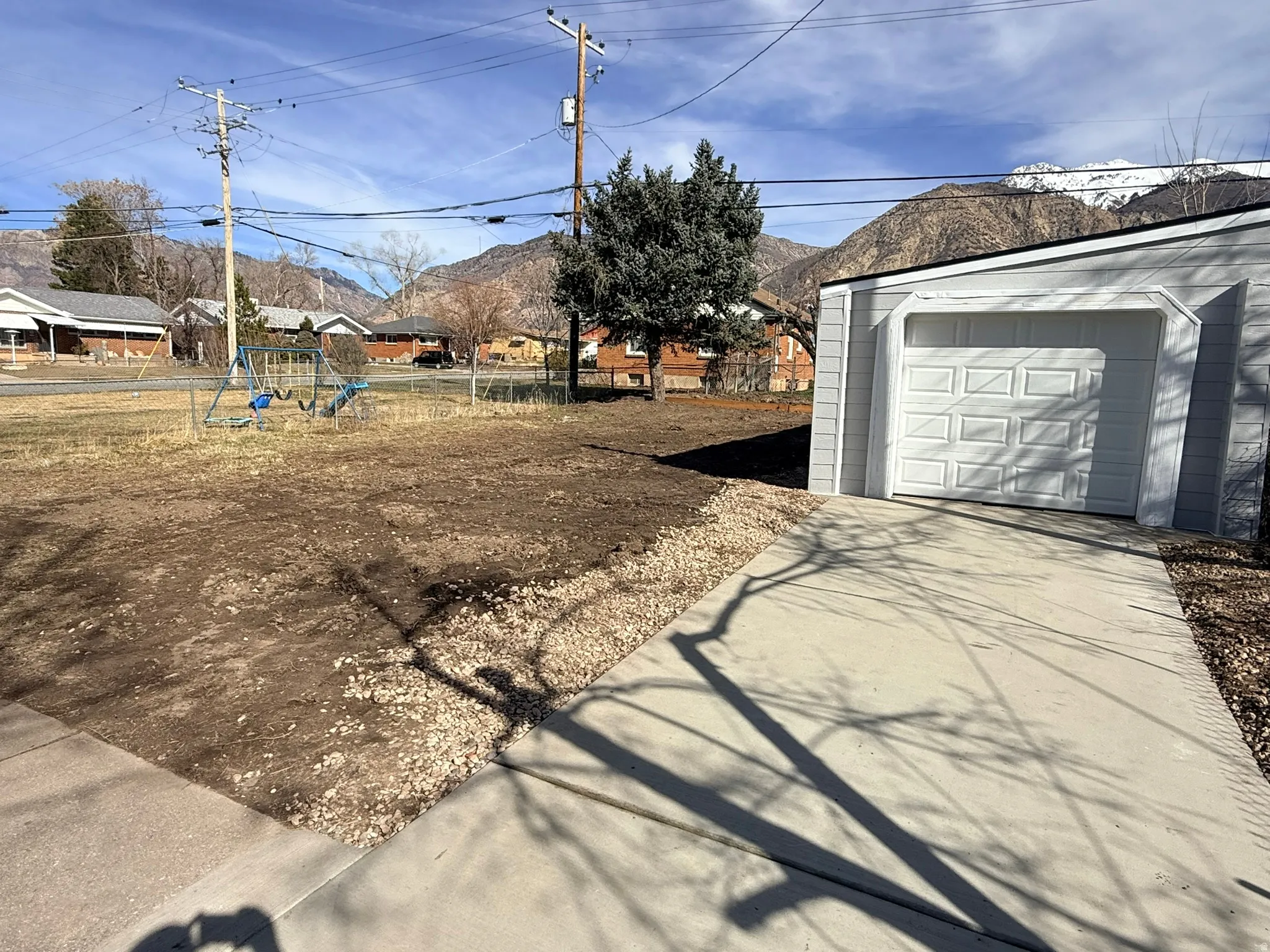 View of yard featuring an outdoor structure and concrete driveway